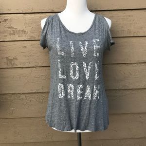 A gray off the shoulder shirt with inspiring words